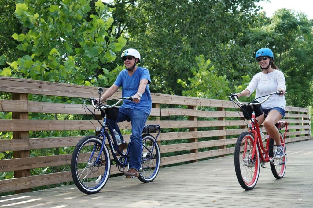 a group of people riding on the back of a bicycle