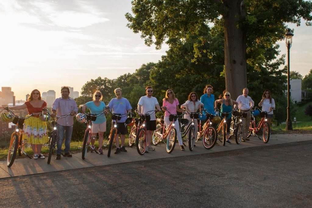 a group of people riding on the back of a bicycle